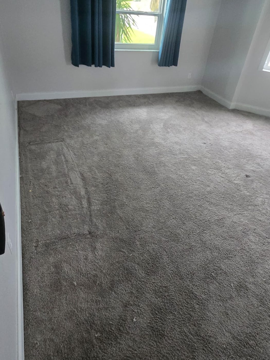 Worn carpet before flooring replacement