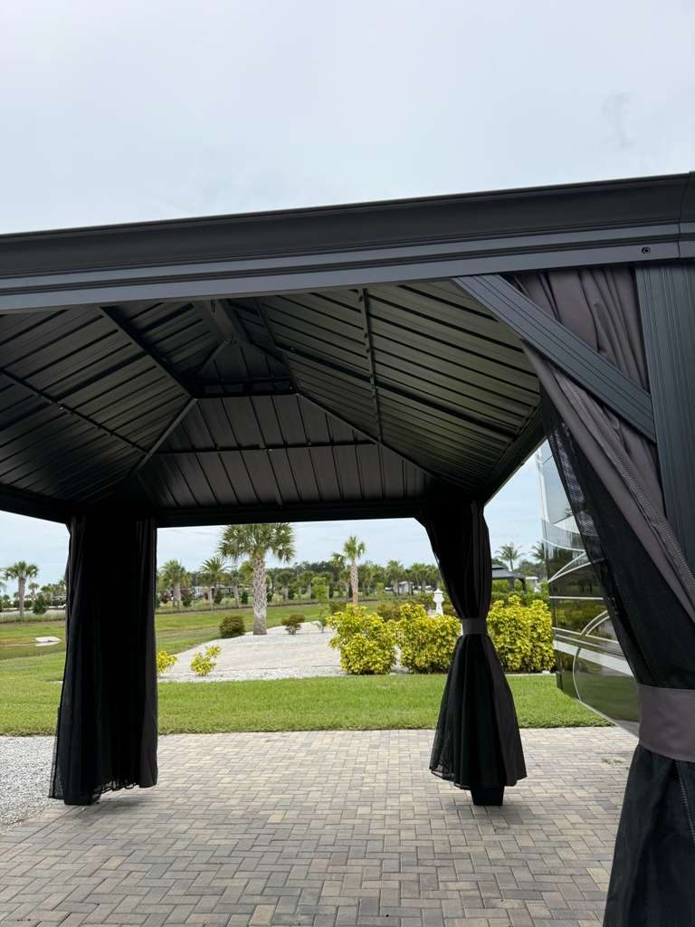 Gazebo with privacy curtains and mosquito netting tied back